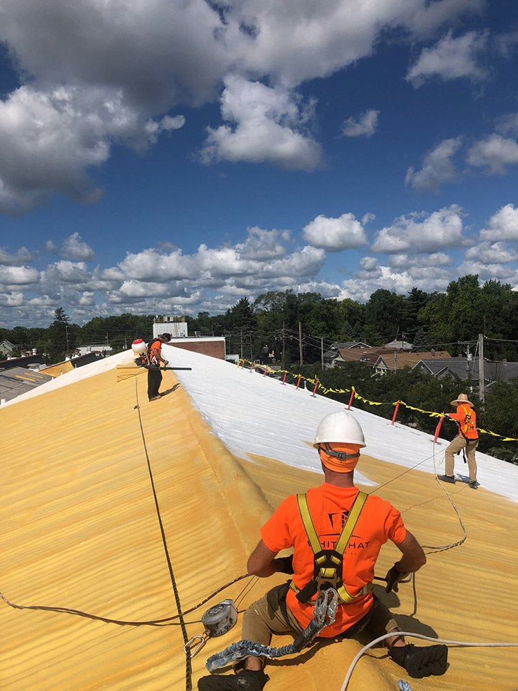 The image is of our team actively restoring a commercial roof.