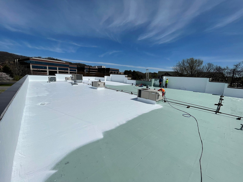 The image is of a commercial roof in the process of being restored.