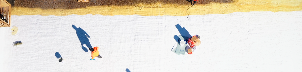 Image is of the White Hat Industrial team in the process of restoring a roof with a SPF system.