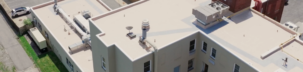 The image is of a medical facility roof restored by the White Hat Industrial team.